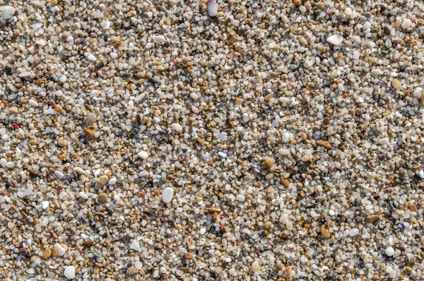 Naturally rounded gravel at sea shore, nature beach background texture