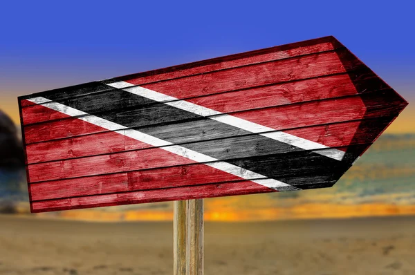 Trinidad and Tobago Flag wooden sign on beach background