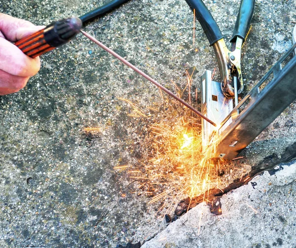 Hard work, welding torch and sparks