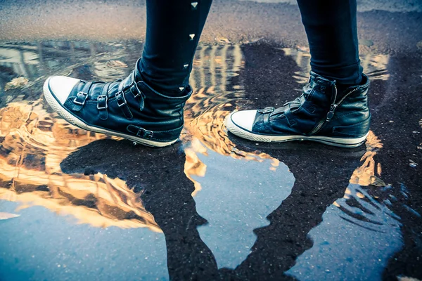 Woman walking on the puddle