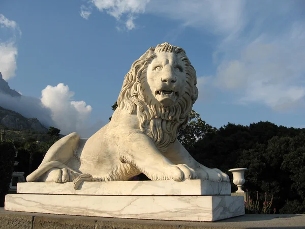 Sculpture of a lion in the setting sun rays