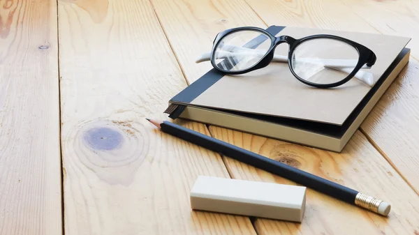 Loft workspace with stationaries on wooden table.