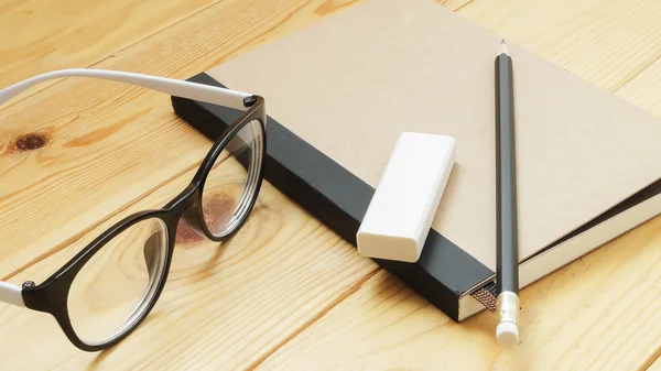 Loft workspace with stationaries on wooden table.