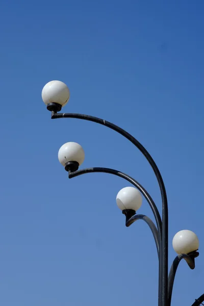 Vintage street lamp over blue sky. Selective focus