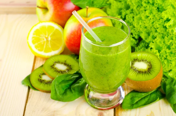 Healthy green smoothie with spinach, kiwi, apples, salad and mint in glass