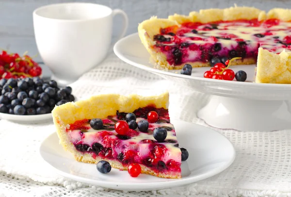 Mix berry tart, pie, cake with raspberries, bilberries, bluberries, red currant and cream
