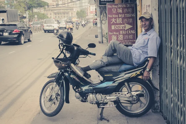 Portrait of a man relaxing on  scooter / motorbike