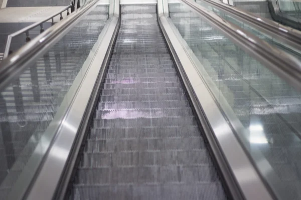 Escalator in metro station looking down