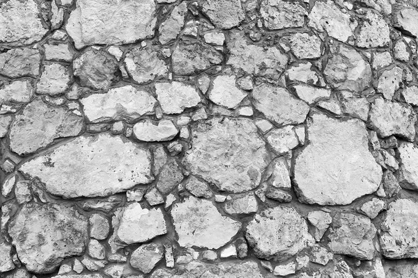 Grunge texture of old white stone walls
