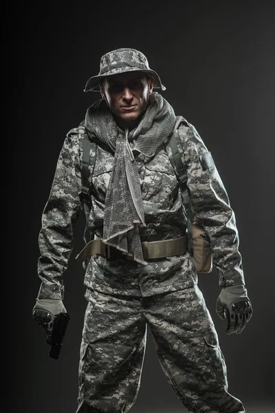 Special forces soldier man with gun on a  dark background