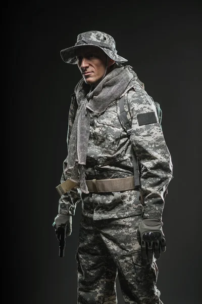 Special forces soldier man with gun on a  dark background