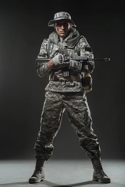 Special forces soldier man with Machine gun on a  dark background