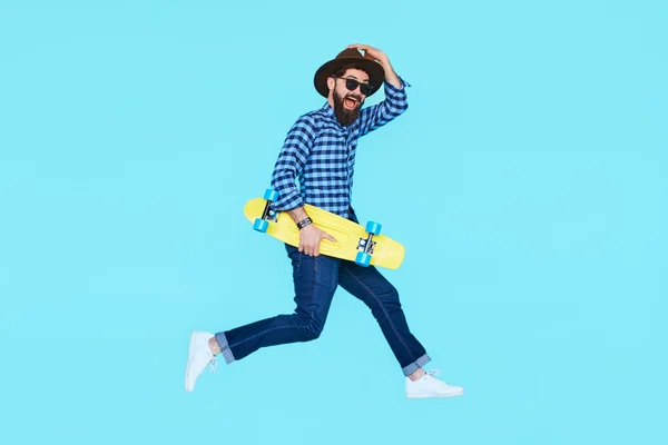 Young man jumping with skateboard