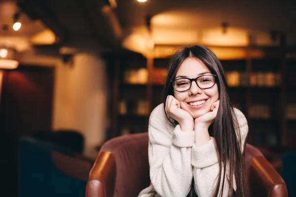 Young smiling brunette woman wearing eye glasses