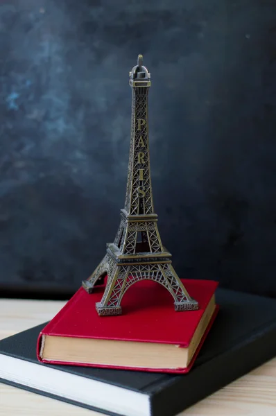 Small metal eiffel tower and two books