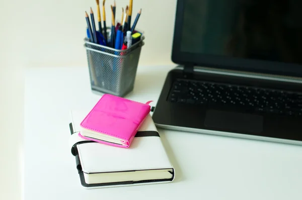 Two notebooks of pink and white color, office stationery