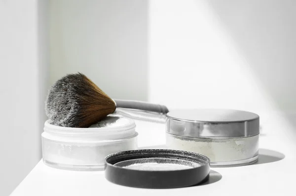 White mineral powder for make-up and big make-up brush