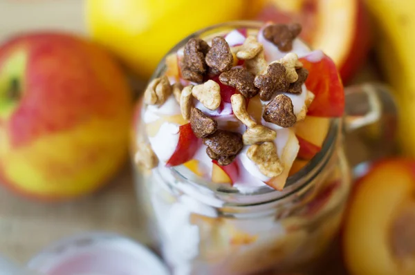 Horizontal photo of fruit salad moixed with yogurt and chocolate