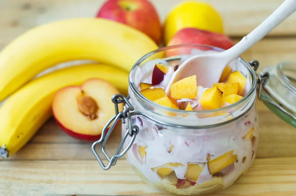 Jar with mixed fruits with fresh homemade yogurt. Fruit salad