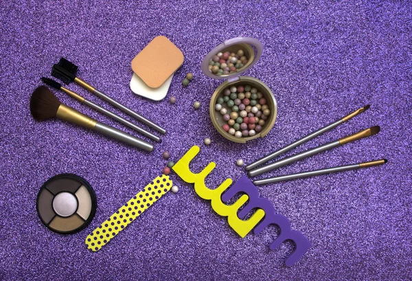 Set of cosmetics and accessories on a brilliant purple background