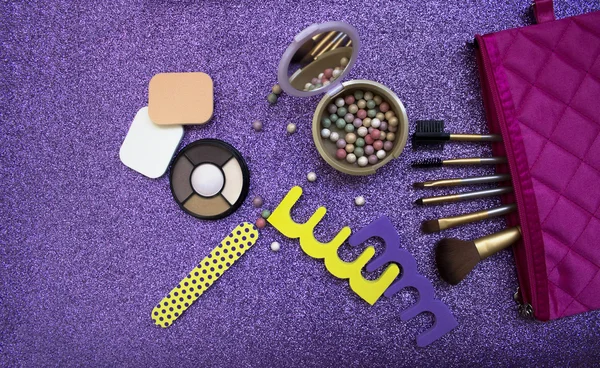 Set of cosmetics and accessories on a brilliant purple background