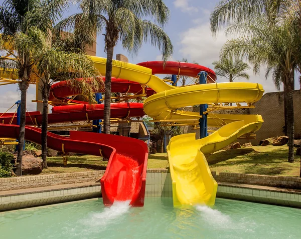 Colorful red and yellow water slide in aqua park. Summer enjoy. Water entertainment.