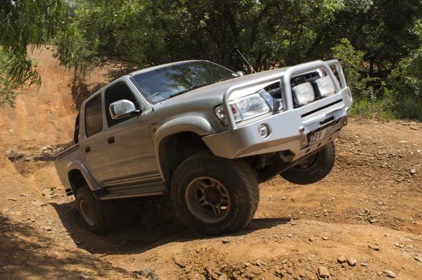 Four-wheel drive vehicle Toyota Hilux is doing off-road.