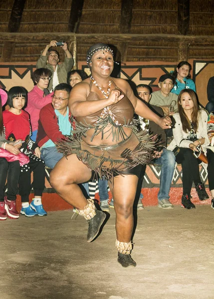 African tribal female ritual dance in traditional handmade costume, bead headdress.