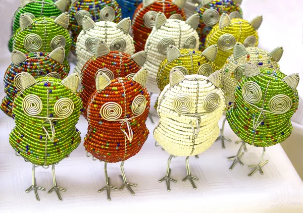 African traditional handmade colorful bead wire toys animal bird owl on white background.