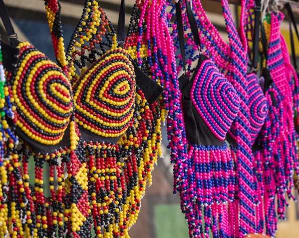 Traditional African colorful handmade beads clothes. Folk art. African market. Ethnic fashion. South Africa, Gauteng, Lesedi Cultural Village (unique center of African culture).