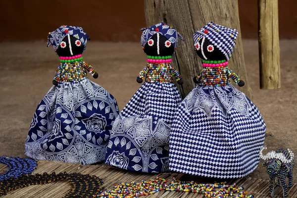 African unique rag dolls in traditional handmade colorful beads and fabrics clothes . Craftsmanship. African fashion Local craft market in South Africa.