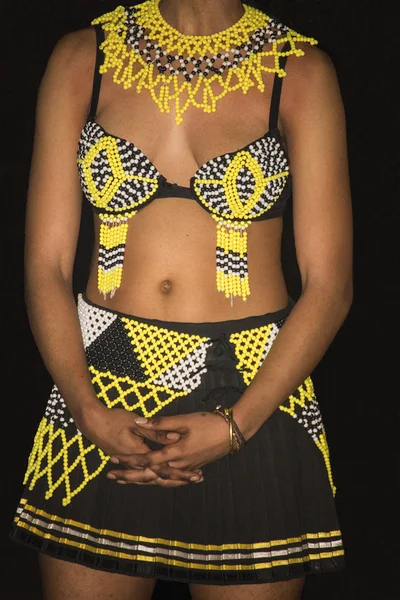 South Africa, Gauteng, Lesedi Cultural Village (unique center of African culture) - 04 July, 2015 . Zulu woman in ethnic handmade colourful yellow white black beads clothes. Traditional tribe costume. African fashion.