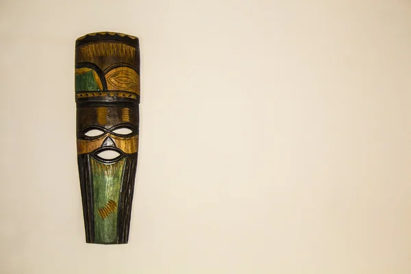 Ethnic tribal ritual handmade mask made from wood on white background. South Africa. Craftsmanship. Souvenir.