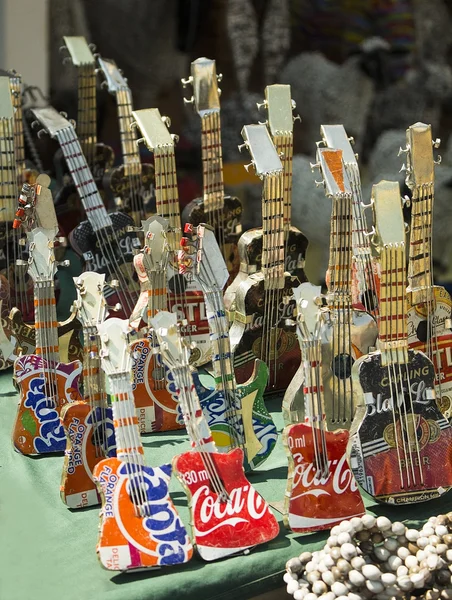 African handmade colorful toys guitar made from beer and drink cans. Modern art. Local craft market.