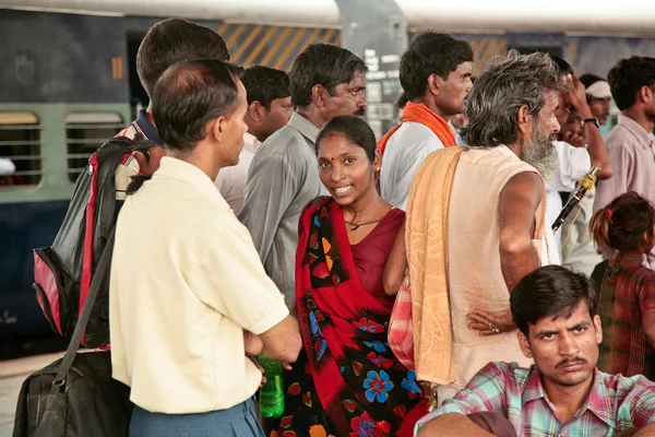 Indian woman in a beautiful sari among men