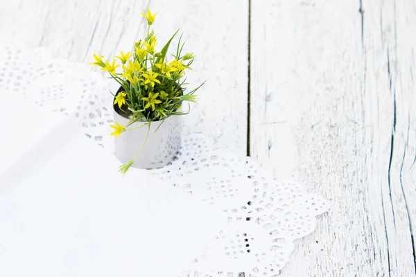 Bouquet of small yellow flowers on a white background blurred