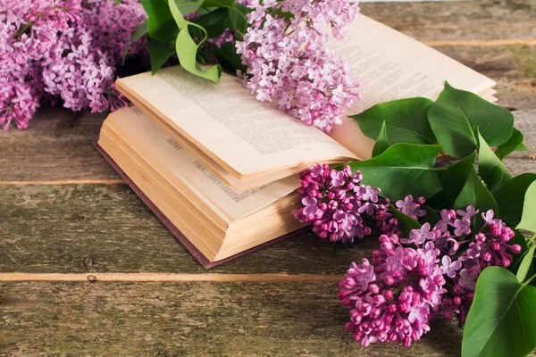 Composition of the flowering branches of lilac and books