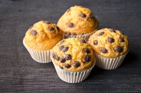 Confectionery product tasty chocolate muffins on wooden background. Delicious cupcake cookies