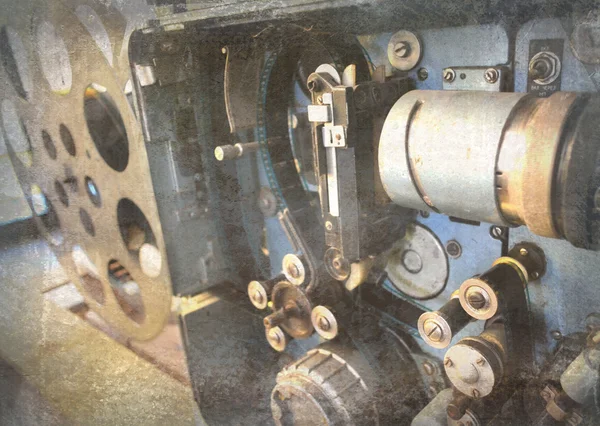 Old and antique commercial movie projector. Vintage projector. Mechanism of the aged theater projector