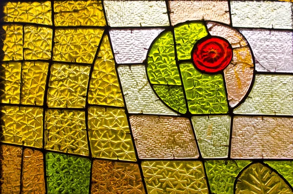 Rectangular and round stained glass window with red rose. Abstract geometric colorful background.