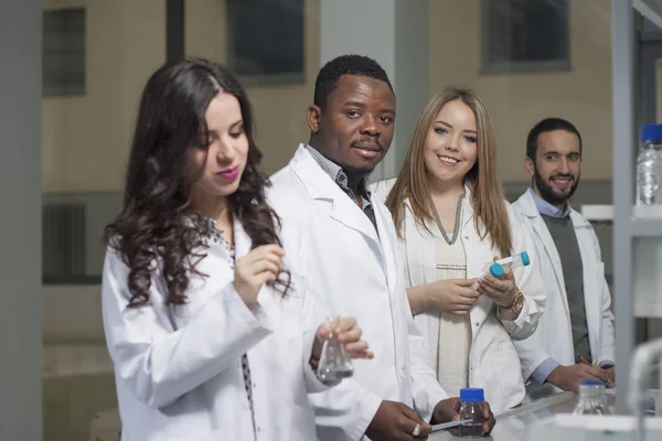 Group of young medical workers are working in lab as lab technic