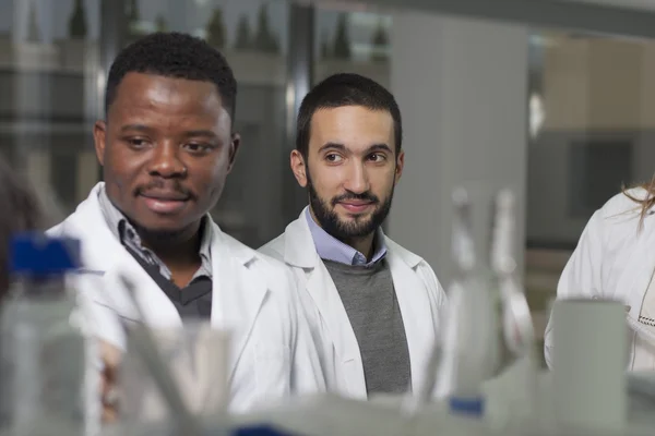 Group of young medical workers are working in lab as lab technic