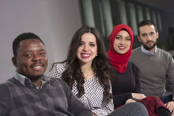 Group of students are hanging out in university hall, mixed-race