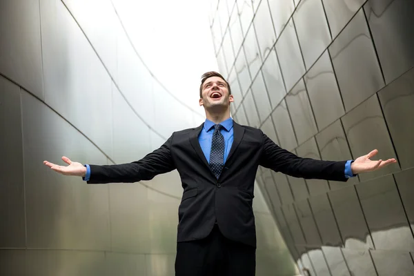 Conceptual freedom wealth success power happiness in a suit tie with urban architecture background