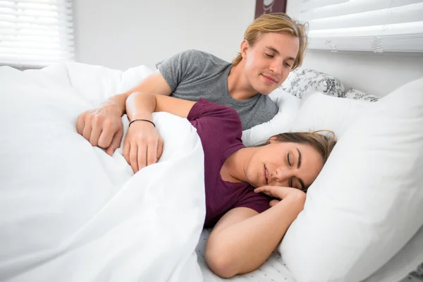 Frustrated male lover upset that wife woman is tired sleeping low energy in bed