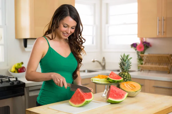 Gorgeous model female brunette in kitchen with organic fruits ingredients lunch breakfast weight loss dieting