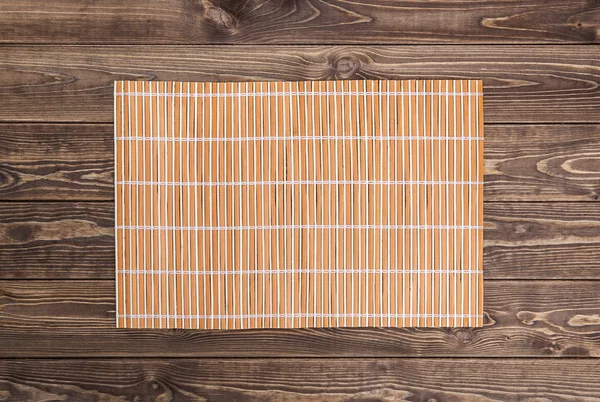 Bamboo napkin on wooden table. top view