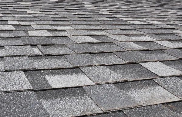 Close up view on Asphalt Roofing Shingles Background. Roof Shingles - Roofing.