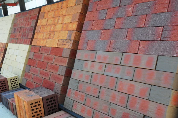 Stacks of various colored concrete pavers (paving stone) or pati