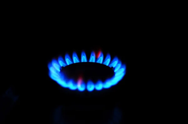 Burning blue gas. Focus on the front edge of the gas burners.